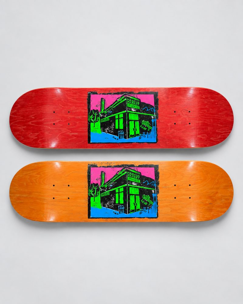 Marcus Market skateboard decks in red and orange with a neon print of the store